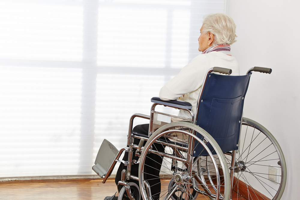 Lonely,Senior,Citizen,Woman,In,Wheelchair,In,A,Nursing,Home